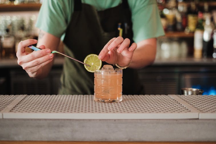 Close up of a bartender making a drink.